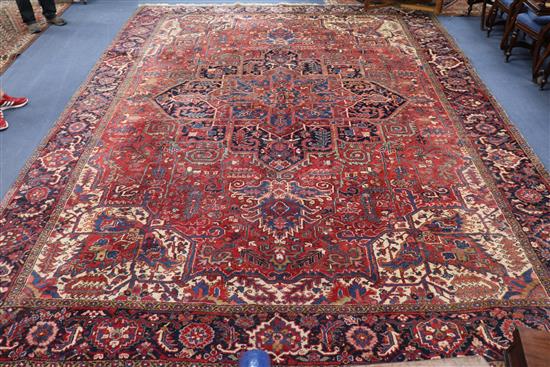 A large Heriz red ground carpet, 470 x 355cm